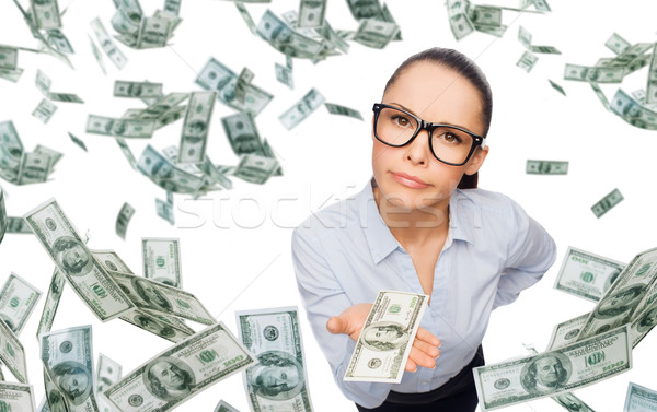 businesswoman with money over blue background Stock photo © dolgachov