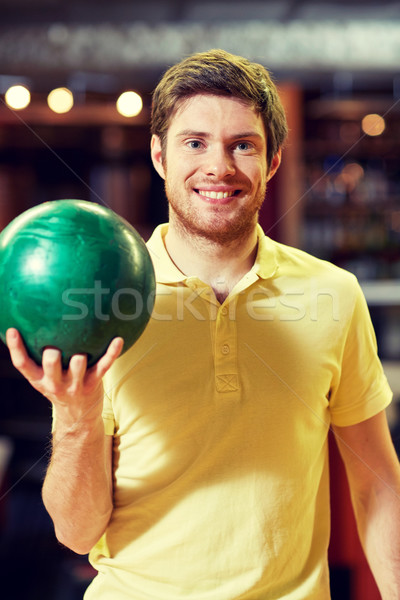 Heureux jeune homme balle bowling club [[stock_photo]] © dolgachov