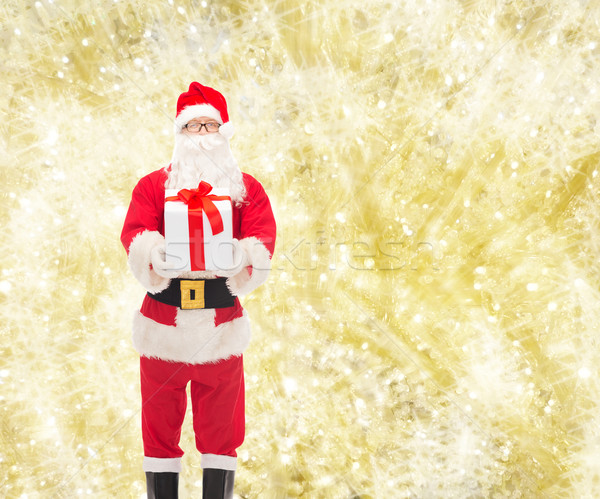 man in costume of santa claus with gift box Stock photo © dolgachov