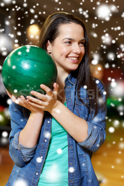 happy young woman holding ball in bowling club Stock photo © dolgachov