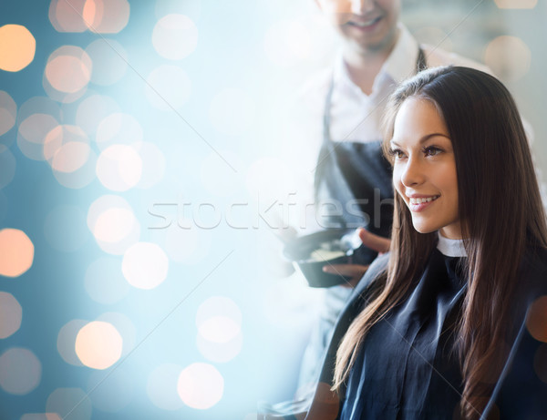 happy young woman coloring hair at salon Stock photo © dolgachov