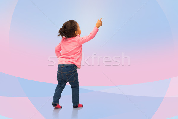 african baby girl pointing finger to something Stock photo © dolgachov