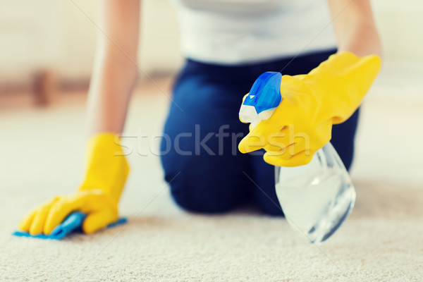 close up of woman with cloth cleaning carpet Stock photo © dolgachov