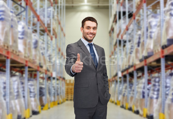 happy man at warehouse showing thumbs up gesture Stock photo © dolgachov