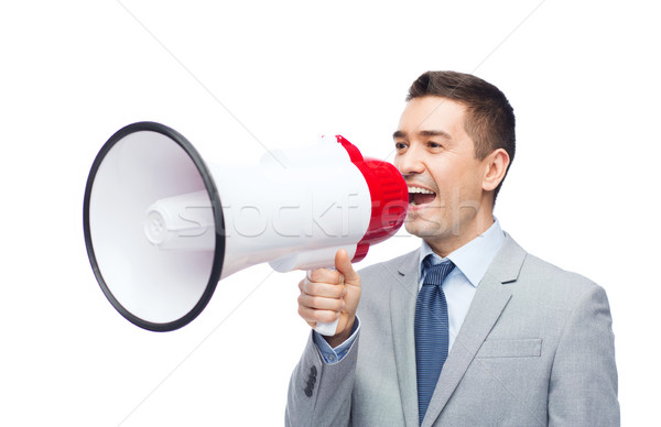 Stock photo: happy businessman in suit speaking to megaphone