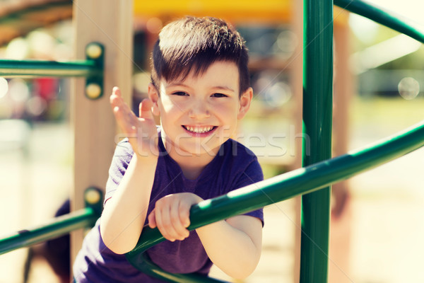 happy little boy climbing on children playground Stock photo © dolgachov