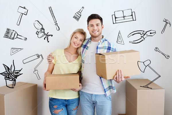 smiling couple with big boxes moving to new home Stock photo © dolgachov