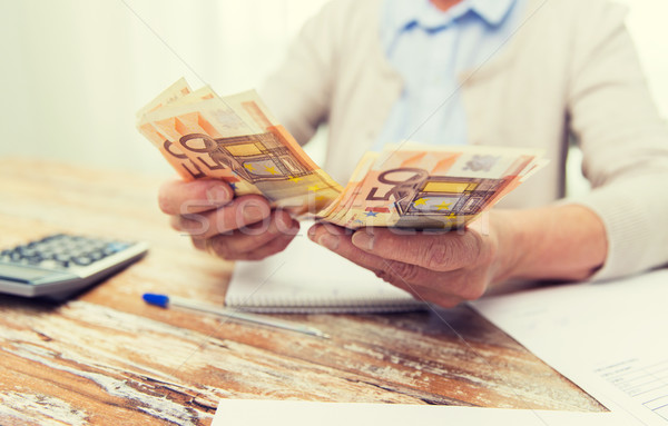close up of senior woman counting money at home Stock photo © dolgachov