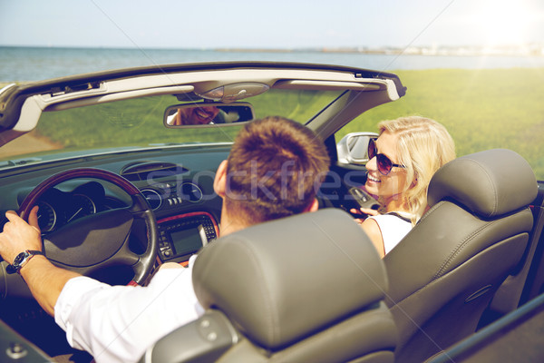 Stock photo: happy man and woman driving in cabriolet car