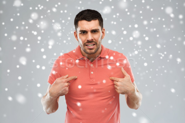 angry man pointing finger to himself over snow Stock photo © dolgachov