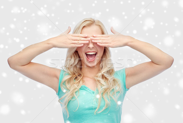 smiling young woman or teen girl covering her eyes Stock photo © dolgachov