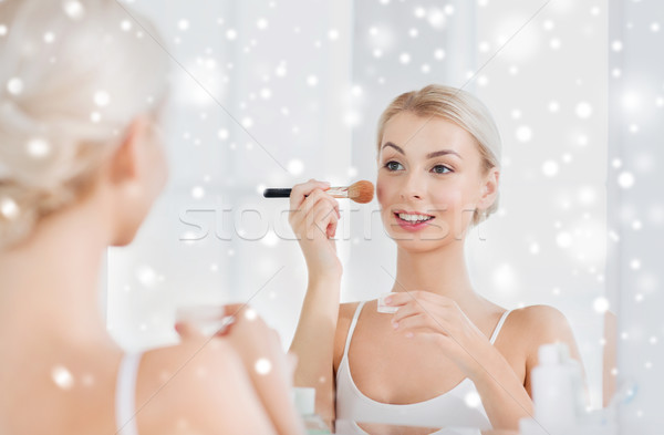 woman with makeup brush and powder at bathroom Stock photo © dolgachov
