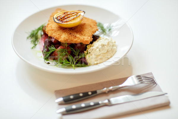 close up of fish salad with roasted lemon on plate Stock photo © dolgachov