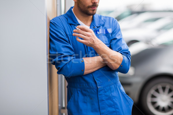 close up of auto mechanic smoking cigarette Stock photo © dolgachov