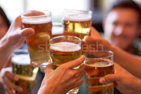 happy friends drinking beer at bar or pub Stock photo © dolgachov