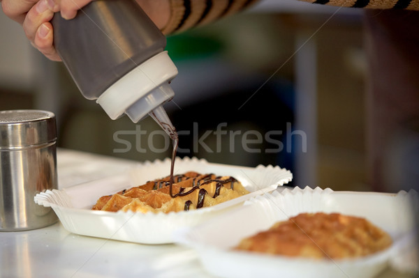 close up of cook adding syrop to waffle Stock photo © dolgachov