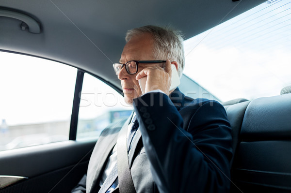 senior businessman calling on smartphone in car Stock photo © dolgachov