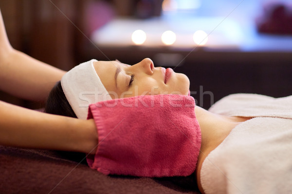 woman having face massage with terry gloves at spa Stock photo © dolgachov