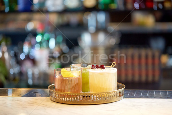 Stock photo: tray with glasses of cocktails at bar