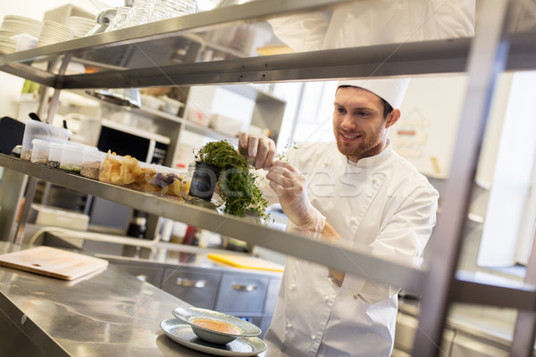 happy male chef cooking at restaurant kitchen Stock photo © dolgachov