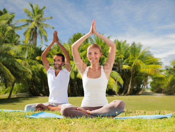 couple doing yoga in lotus pose outdoors Stock photo © dolgachov