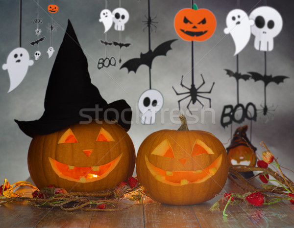 carved pumpkins in witch hat and halloween garland Stock photo © dolgachov