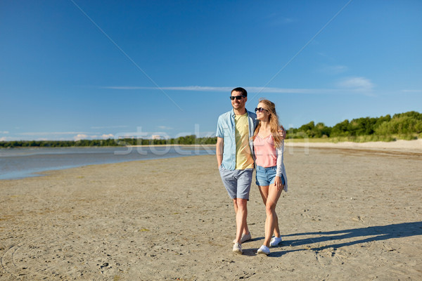 happy couple walking along summer beach Stock photo © dolgachov