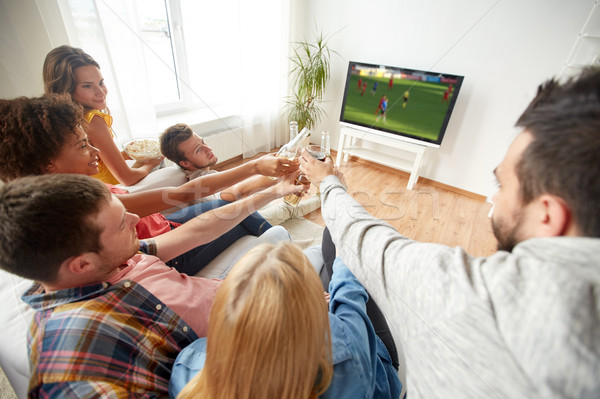 friends with beer watching football or soccer game Stock photo © dolgachov