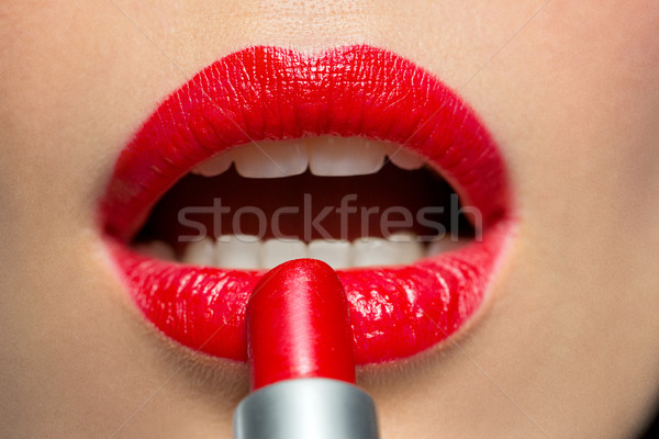 close up of woman applying red lipstick to lips Stock photo © dolgachov