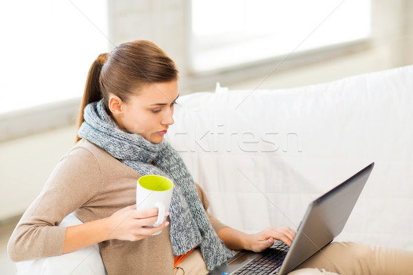 diseased woman in scarf using laptop at home Stock photo © dolgachov