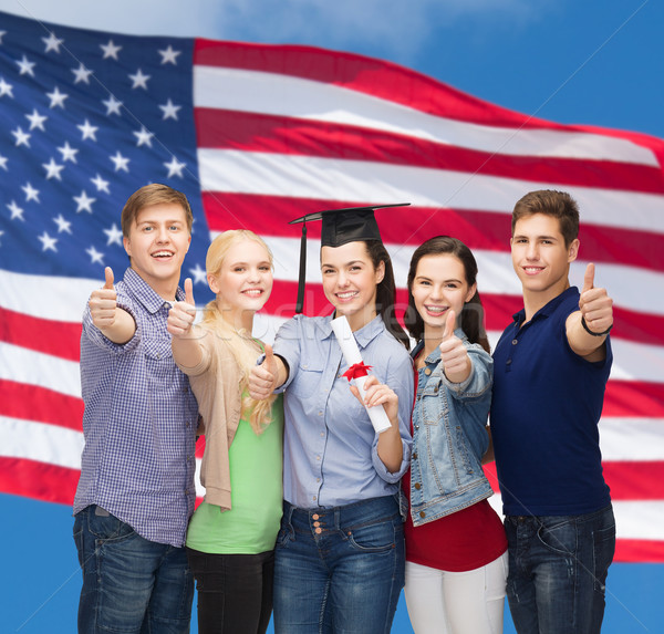 group of students with diploma showing thumbs up Stock photo © dolgachov