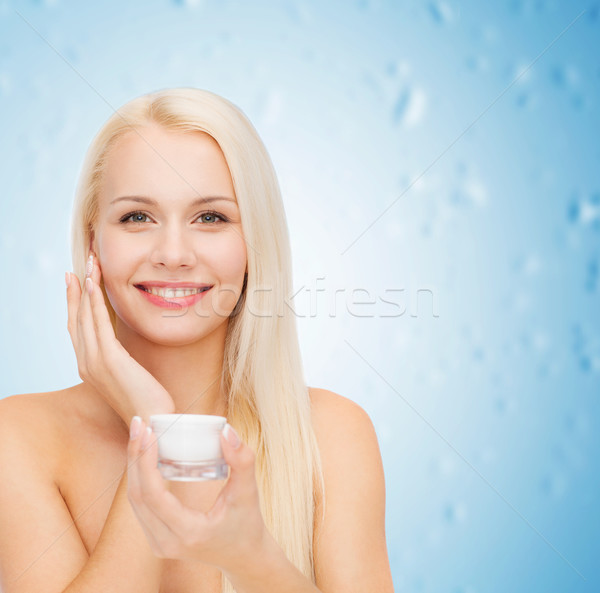 woman applying cream on her skin Stock photo © dolgachov