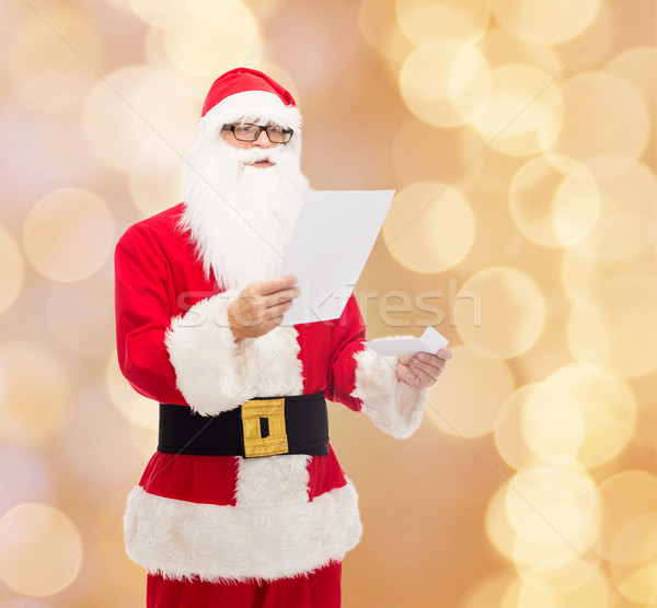 man in costume of santa claus with letter Stock photo © dolgachov