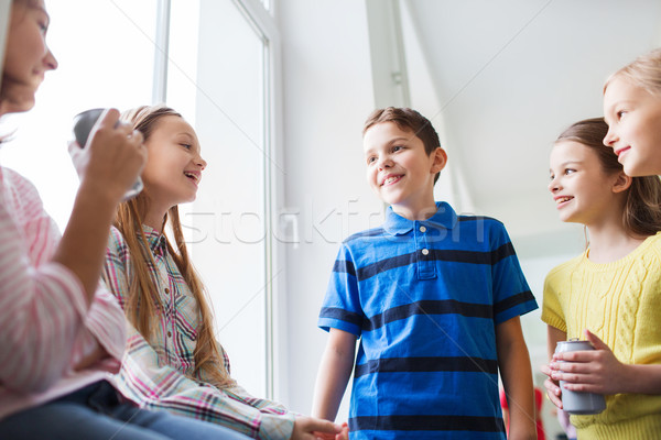 group of school kids with soda cans in corridor Stock photo © dolgachov