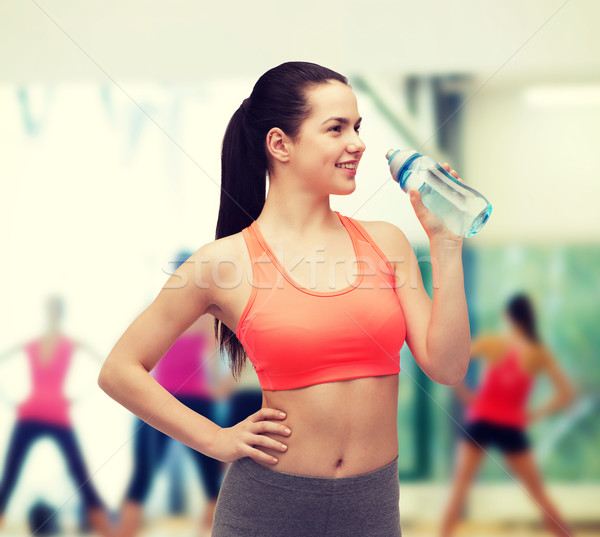 sporty woman with water bottle Stock photo © dolgachov