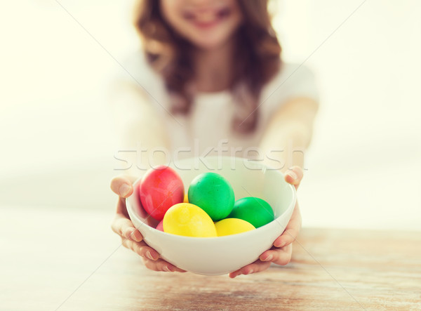 close up of girl holding bowl with colored eggs Stock photo © dolgachov