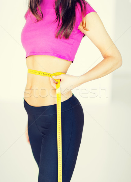 trained belly with measuring tape Stock photo © dolgachov