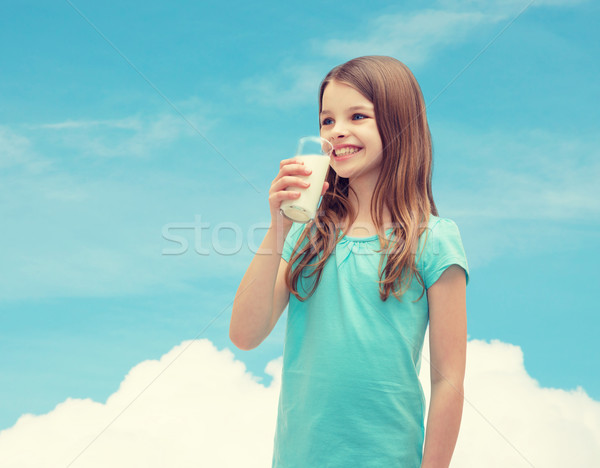 smiling little girl drinking milk out of glass Stock photo © dolgachov