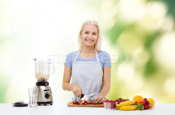 smiling woman with blender preparing shake Stock photo © dolgachov
