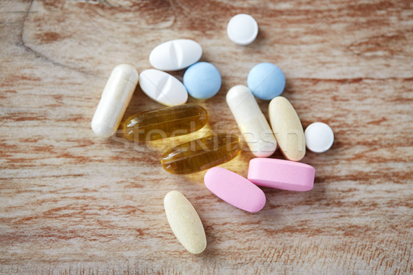 Stock photo: pills and omega 3 oil capsules on table