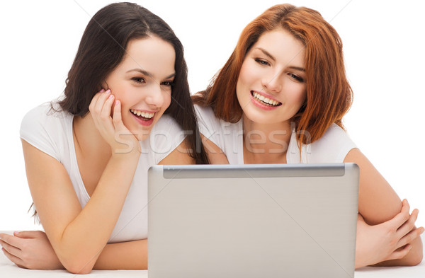 Stock photo: two smiling teenage girls with laptop computer