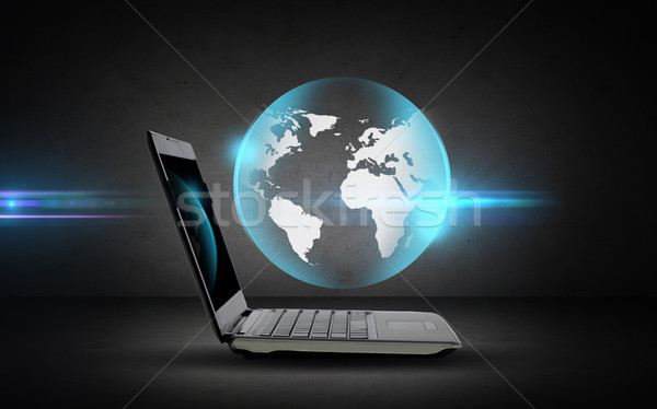 open laptop computer with globe projection Stock photo © dolgachov