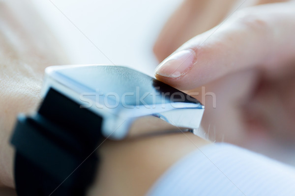 close up of hands setting smart watch Stock photo © dolgachov