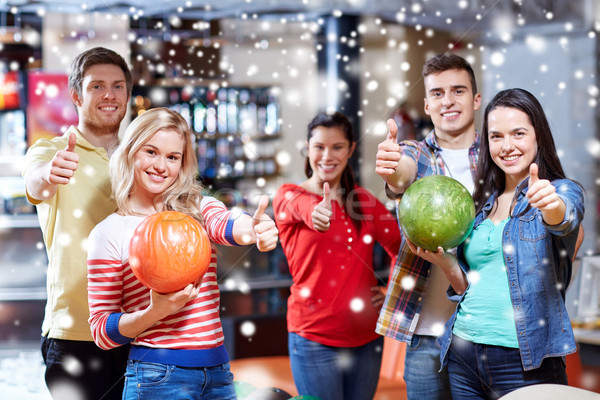 happy friends in bowling club showing thumbs up Stock photo © dolgachov