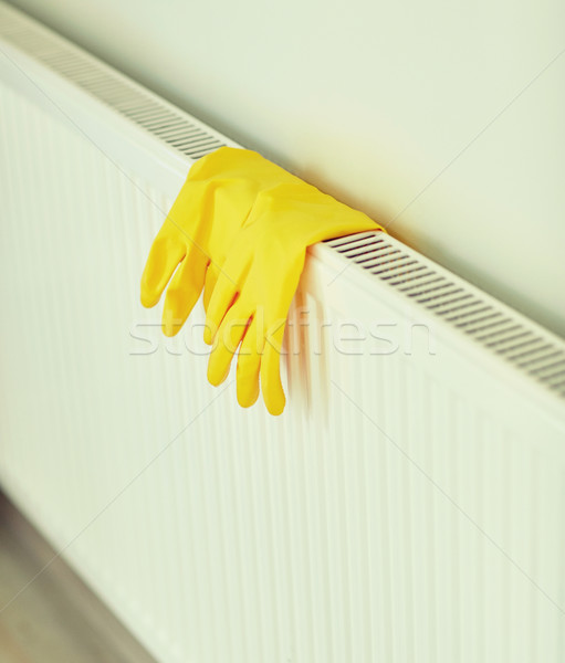 close up of rubber gloves hanging on heater Stock photo © dolgachov