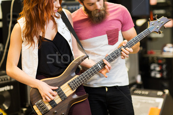 couple of musicians with guitar at music store Stock photo © dolgachov