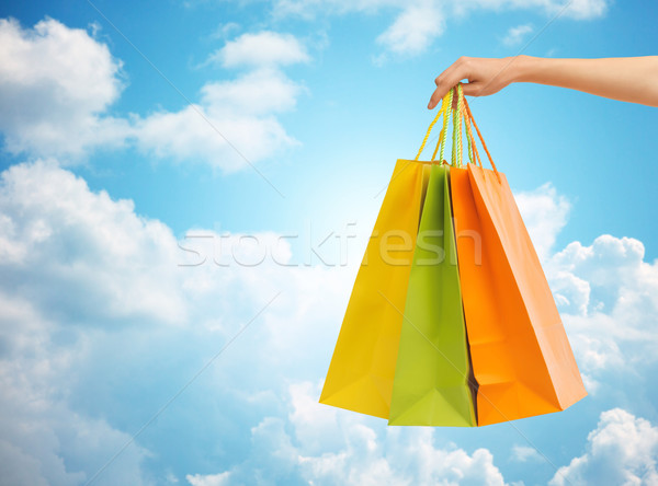 Stock photo: close up of hand holding shopping bags