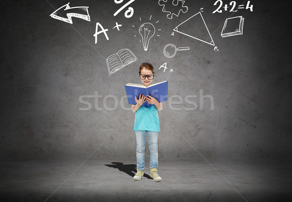 little girl in eyeglasses reading math textbook Stock photo © dolgachov