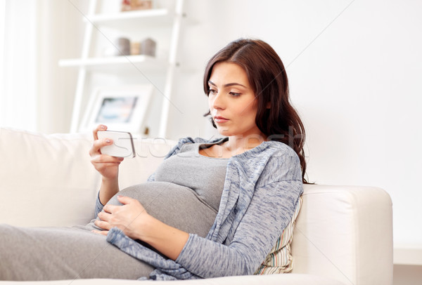 Triste donna incinta smartphone home gravidanza maternità Foto d'archivio © dolgachov