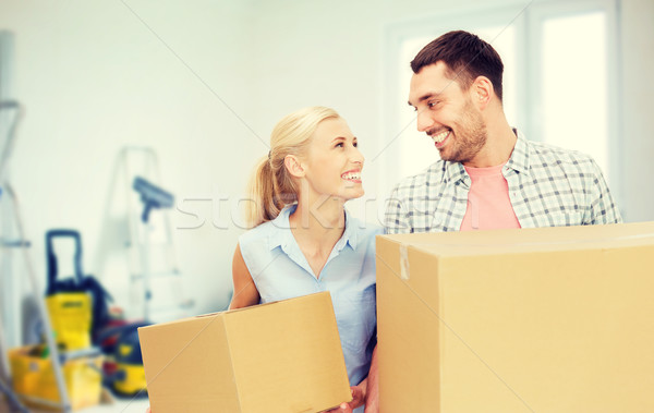 couple with cardboard boxes moving to new home Stock photo © dolgachov